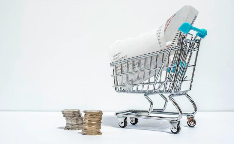 Shopping cart with purchased receipt and euro coins